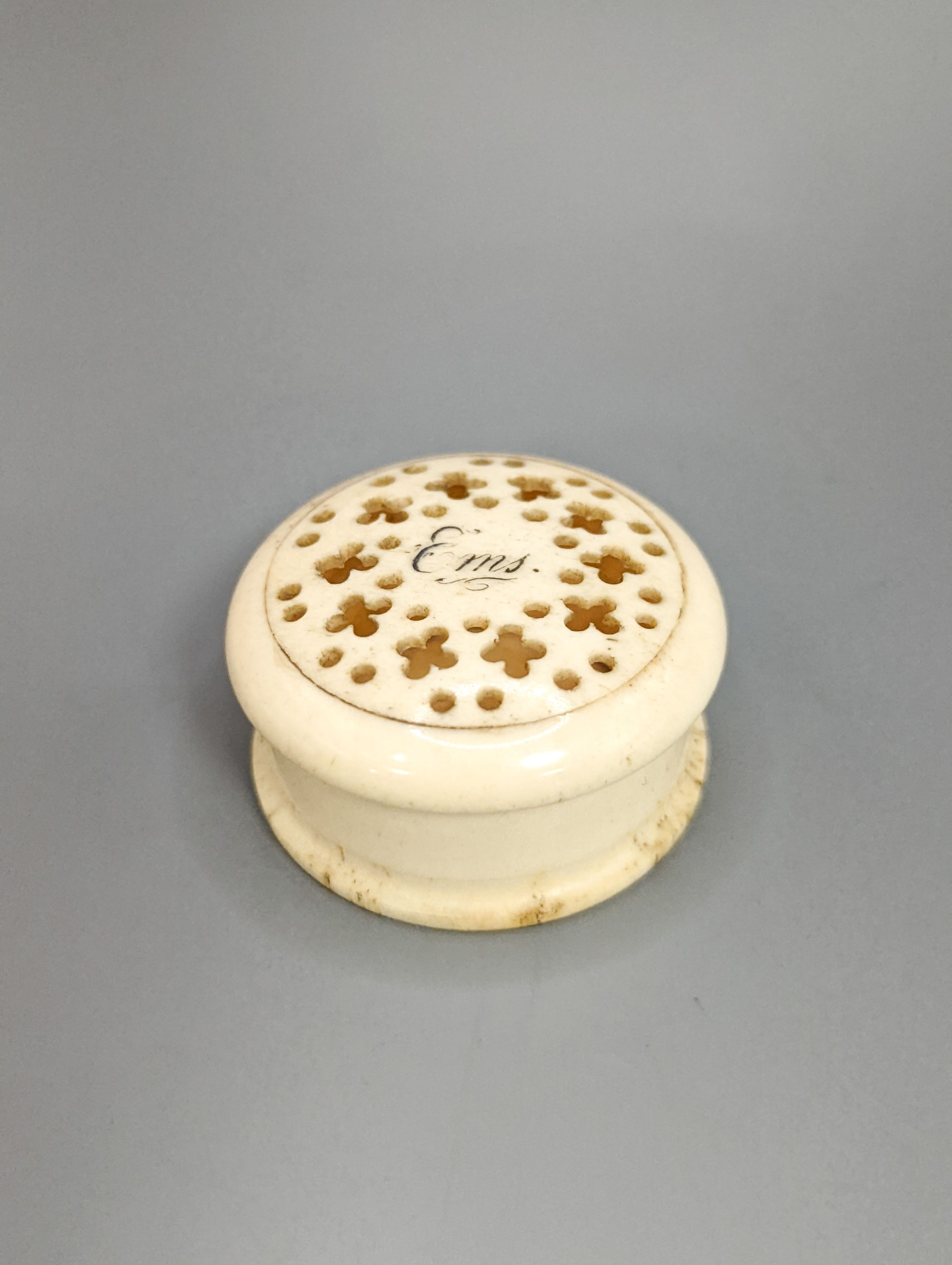 An early 19th century ivory circular box with central cartouche, a tortoiseshell match holder, diameter 9cm, and a pierced pot
